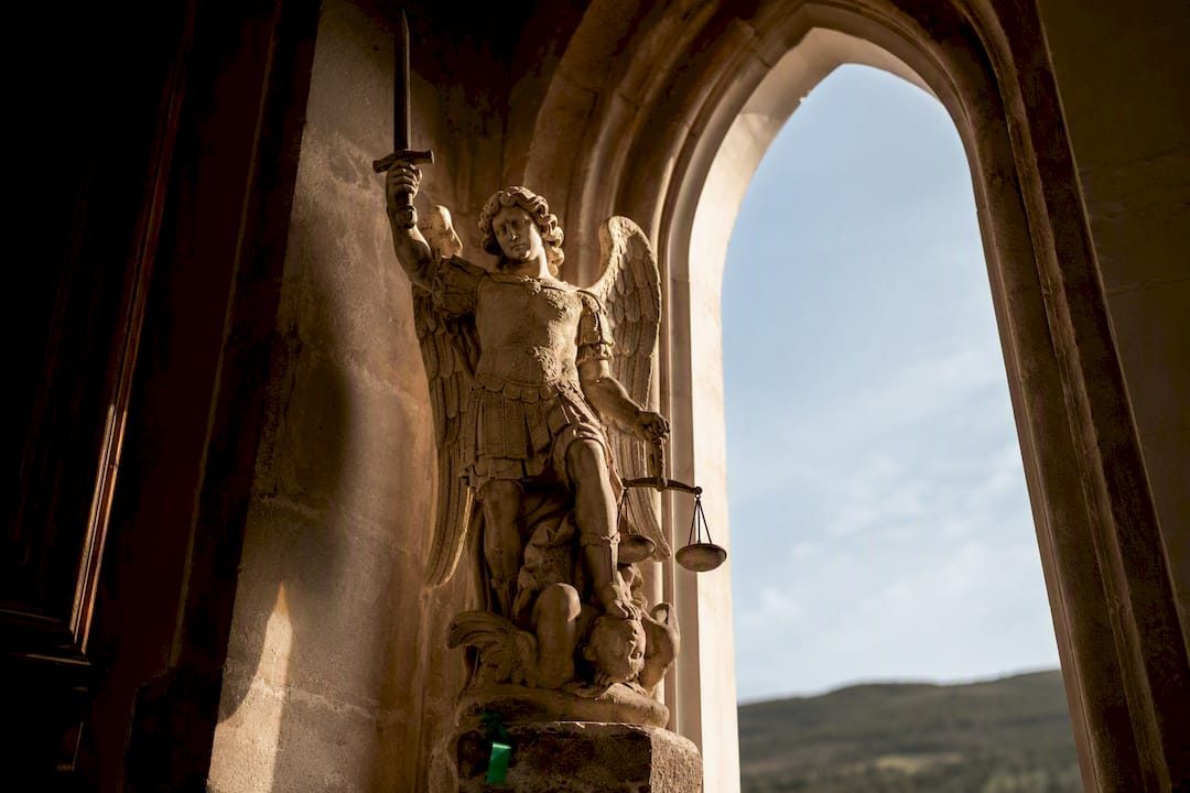 Saint Michael statue in a shadowed shrine