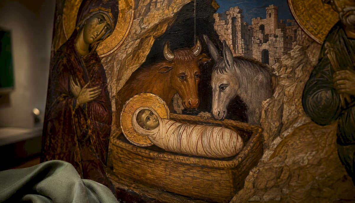 Nativity artwork detail with manger ox and ruins